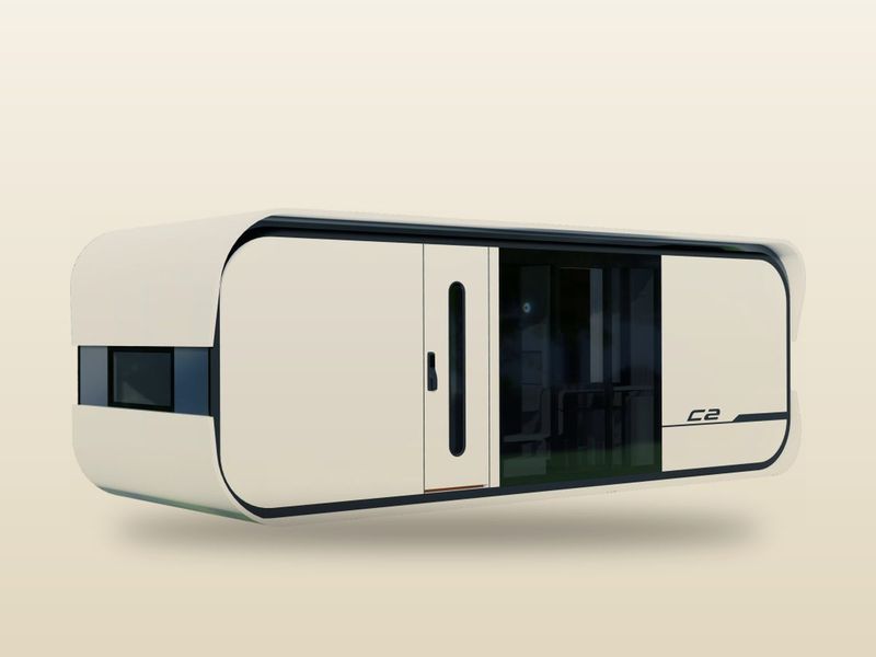 Nestron Cube Two tiny home: a longer white rounded pod with a glass sliding door